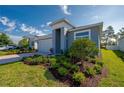 Well-maintained home featuring lush landscaping, a brick paver driveway, and attached garage at 887 Lake Hill Way, Deland, FL 32724