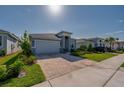 Charming single-story home with a two-car garage and manicured front yard at 887 Lake Hill Way, Deland, FL 32724