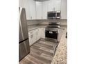 Well-equipped kitchen featuring stainless steel appliances, modern cabinetry, and granite countertops at 926 Clover St, Deland, FL 32720