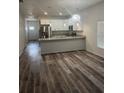 Open-concept dining and kitchen area with stainless steel appliances and modern countertops at 926 Clover St, Deland, FL 32720