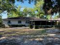 An expansive backyard with a screened-in porch is surrounded by beautiful trees and shrubs, providing privacy at 1120 Arden St, Longwood, FL 32750