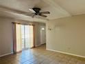 Bright living room with tile floors, neutral paint, large window, and ceiling fan, flooded with natural light at 1120 Arden St, Longwood, FL 32750