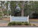 Entrance to the community, 'Lake Lindley Village', is marked by a welcoming sign amidst green foliage at 1250 Lemonwood Ave, Deland, FL 32724