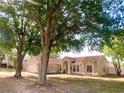 Inviting single-story home with well-maintained lawn and mature trees providing shade at 1311 Fallwood Dr, Deltona, FL 32725