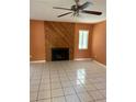 Inviting living room with a decorative fireplace, tile floor, and a ceiling fan at 132 Wax Myrtle Ct, Sanford, FL 32773