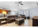 Inviting living room featuring hardwood floors, a ceiling fan, and comfortable leather furniture at 133 Brasswood Ct, Daytona Beach, FL 32117