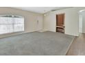 Spacious living room with large windows providing natural light and neutral carpet and paint at 1450 14Th St, Orange City, FL 32763
