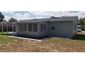 Exterior view of home with a covered patio and lush greenery at 1626 S Page Dr, Deltona, FL 32725