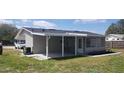 Back exterior of the house with a covered patio, and lots of natural light at 1626 S Page Dr, Deltona, FL 32725