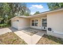 Close up of a house featuring a two-car garage, well-maintained landscaping, and a welcoming front entrance at 1890 15Th St, Orange City, FL 32763
