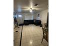 Spacious living room with tile floors and a comfortable black sectional sofa at 2219 Howland Blvd, Deltona, FL 32738