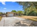 Charming single-story home featuring an attached garage and long driveway at 2327 Mulbry Dr, Winter Park, FL 32789