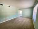 Spacious living room with carpet flooring and bright natural light at 2332 Hadley St, Deltona, FL 32738