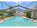 Inviting screened-in pool area with a clear blue pool, perfect for relaxation and outdoor enjoyment at 2416 Candlewick St, Deltona, FL 32738