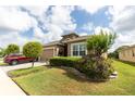 Charming single-Gathering home with a neutral color palette and beautifully landscaped front yard at 2435 Pawtucket Pass, Mount Dora, FL 32757