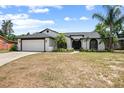 Charming single-story home with a well-manicured lawn, a two-car garage, and lovely landscaping at 245 Rosita Dr, Debary, FL 32713