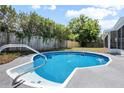 Backyard pool featuring light blue tile, concrete surround, and a privacy fence at 245 Rosita Dr, Debary, FL 32713