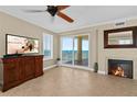 Inviting living room boasts a fireplace, media cabinet, and breathtaking ocean views through sliding glass doors at 2515 S Atlantic Ave # 1001, Daytona Beach Shores, FL 32118