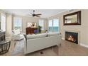 Bright living room featuring cozy fireplace, and stunning ocean views through large sliding glass doors at 2515 S Atlantic Ave # 1001, Daytona Beach Shores, FL 32118