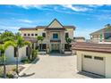 Stately home with a grand facade, barrel tile roof, paver driveway, mature landscaping and large windows at 2636 S Peninsula Dr, Daytona Beach, FL 32118