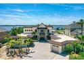 Waterfront home boasting a barrel tile roof, paver driveway, meticulous landscaping, and stunning water views at 2636 S Peninsula Dr, Daytona Beach, FL 32118