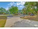 Circular driveway leading to a well-manicured property with mature trees and landscaping at 2704 Burgoyne Pl, Deland, FL 32720