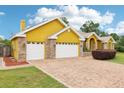 Charming single-story home with a two-car garage, brick accents and long brick driveway at 2940 Se 23Rd Ave, Ocala, FL 34471