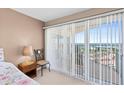 Cozy bedroom features sliding glass doors to a balcony with stunning city views at 2967 S Atlantic Ave # 1601, Daytona Beach Shores, FL 32118