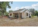 View of the side of the home, showing the screened porch, siding, and fenced yard at 31544 Wekiva River Trl, Sorrento, FL 32776
