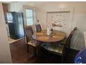 Bright kitchenette featuring a round table, seating for four, and a refrigerator at 317 Inwood Ave, New Smyrna Beach, FL 32168