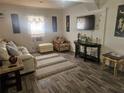 Inviting living room featuring wood-look floors, a large window, and comfortable seating at 317 Inwood Ave, New Smyrna Beach, FL 32168