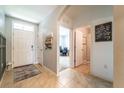 Inviting entryway with light tile flooring, neutral walls, and decorative farmhouse accents at 343 Lazio Cir, Debary, FL 32713