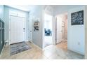 Bright foyer with tile flooring featuring front door, side door, and an entrance to a room at 343 Lazio Cir, Debary, FL 32713