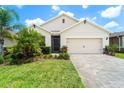 Charming single-story home with well-manicured lawn, stone accents, and paver driveway at 343 Lazio Cir, Debary, FL 32713