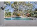 Enjoy the outdoors with a private screened-in pool area, lush greenery, and a sparkling pool at 3601 Galway Ln, Ormond Beach, FL 32174