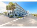 Full exterior view of Mariner's Cove showcasing parking and lush landscaping at 3700 S Atlantic Ave # 413, New Smyrna Beach, FL 32169