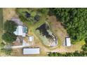 Aerial view of the property highlighting the house, pool, outbuildings and two ponds at 4145 Rambler Ave, St Cloud, FL 34772