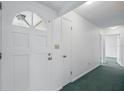 Bright entryway with white walls leading to other rooms in the home at 44 Fairway Cir, New Smyrna Beach, FL 32168