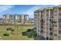 Beautiful building with multiple balconies overlooking lawn and ocean at 4670 Links Village Dr # A506, Ponce Inlet, FL 32127