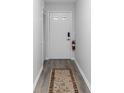 Clean entryway featuring durable flooring, a fire extinguisher, and a neutral color scheme at 576 Belltower Ave # 100, Deltona, FL 32725