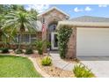 Inviting front entrance with brick facade, walkway, and lush landscaping at 5776 White Acres Ln, Port Orange, FL 32127