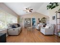 Spacious living room featuring vaulted ceilings, hardwood floors, and plenty of natural light at 5776 White Acres Ln, Port Orange, FL 32127