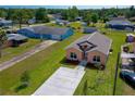 Aerial view of cozy home with neat landscaping, concrete driveway, and proximity to other properties at 707 Hamilton St, New Smyrna Beach, FL 32168
