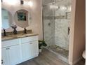 Spa-like bathroom with a double vanity, modern finishes, and a glass-enclosed shower at 707 Hamilton St, New Smyrna Beach, FL 32168