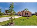 Inviting single-Gathering home featuring a well-maintained lawn and concrete driveway at 707 Hamilton St, New Smyrna Beach, FL 32168