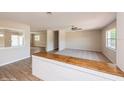 Bright living room with new carpet, and wood-look floors showcasing an open concept design at 810 Sylvia Dr, Deltona, FL 32725