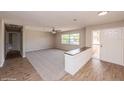 Bright living room with new carpet, and wood-look floors showing an open concept design at 810 Sylvia Dr, Deltona, FL 32725