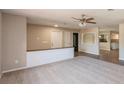 Open concept living room with new flooring and view of the kitchen at 810 Sylvia Dr, Deltona, FL 32725