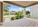 Inviting covered front porch with brick flooring and view of lush landscaping at 8832 Ribault Ave, Orlando, FL 32832