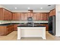Spacious kitchen with dark wood cabinetry, granite countertops, backsplash and stainless steel appliances at 8832 Ribault Ave, Orlando, FL 32832